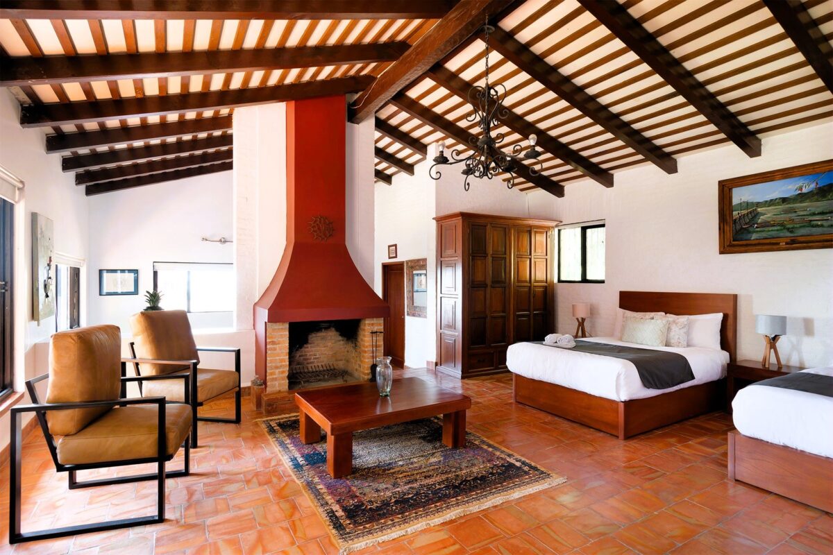 Master bedroom with cozy bedding and panoramic garden views in Ajijic Airbnb