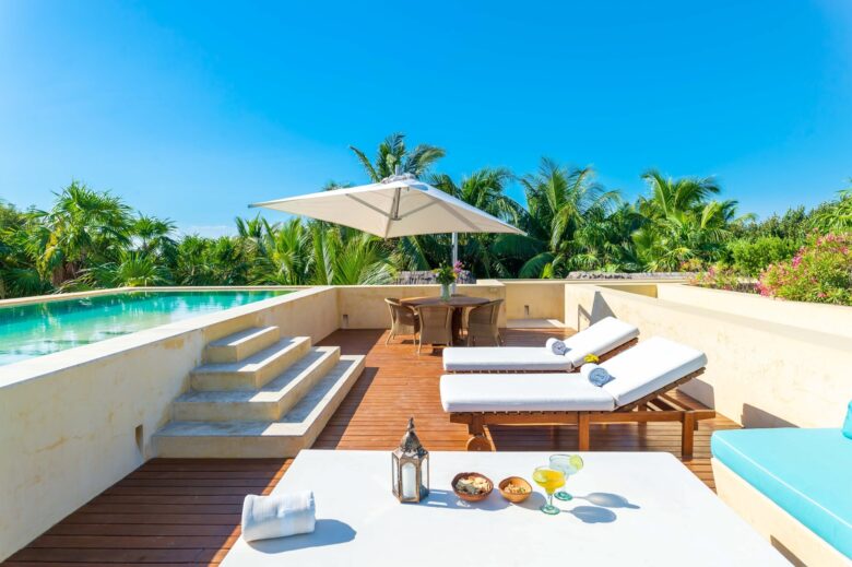 Luxury poolside with lounge chairs and tropical drinks at ANANA Hacienda Chekul